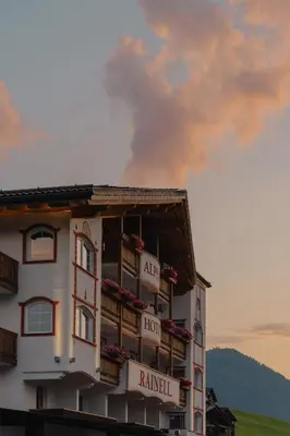 a hotel building with a sign on the side of it at Rainell Dolomites Retreat in Ortisei
