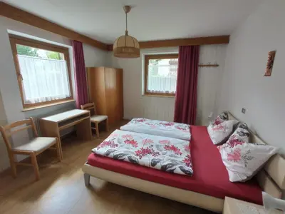 a bedroom with two beds next to a window at Haus Peskoller in Chienes