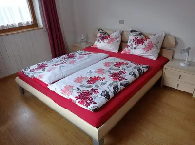 a room with two beds and a window at Haus Peskoller in Chienes
