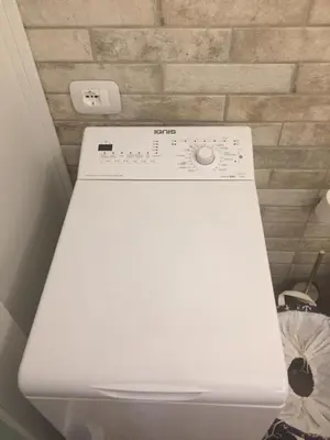 a white washing machine sitting in a room at Casa di Micky in Canale San Bovo