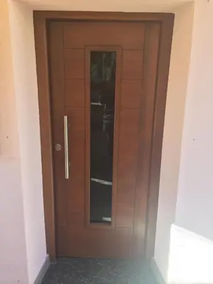 a wooden door in a room at Casa di Micky in Canale San Bovo