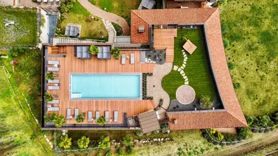 an overhead view of a pool with chairs and umbrellas at Hotel Kassian in Lagundo