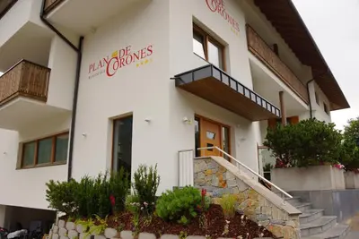 a white building with a staircase in front of it at PLAN DE CORONES apartments in San Vigilio Di Marebbe