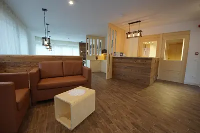 a living room with a couch and a table at PLAN DE CORONES apartments in San Vigilio Di Marebbe