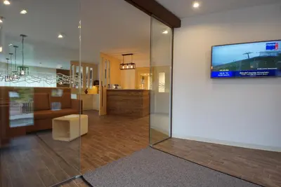 a living room with a television on a wall at PLAN DE CORONES apartments in San Vigilio Di Marebbe