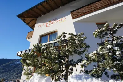 a building with a sign for the new chocolates at PLAN DE CORONES apartments in San Vigilio Di Marebbe