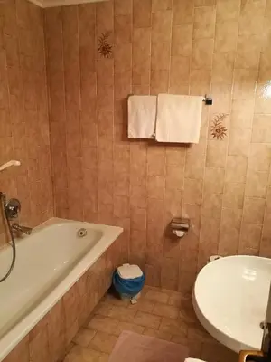 a bathroom with a tub and a toilet and a sink at Residence Terentis in Terento