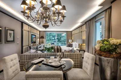 a living room with a couch and a table and chairs at Villa Eden a member of Leading Hotels of the World in Merano