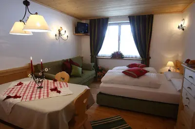 a living room with two beds and a couch at Apartments Sol E Nef in Rocca Pietore