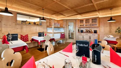 a dining room with tables and chairs in a restaurant at Proderhof in Laion