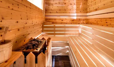 a wooden sauna with a bench in the middle at Proderhof in Laion