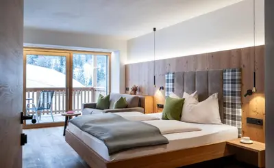 a bedroom with a large bed and a balcony at Proderhof in Laion