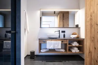 a bathroom with a sink and a mirror at Proderhof in Laion