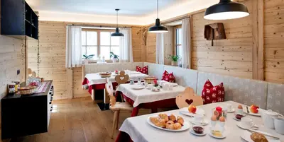 a restaurant with two tables with food on them at Proderhof in Laion