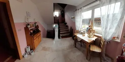 a living room with a table and a window at Landhaus Weingut in Cornaiano