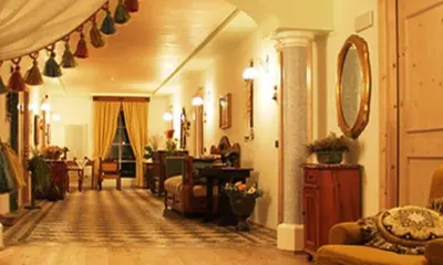 a living room filled with furniture and a room with at Locanda Alpina in Brez