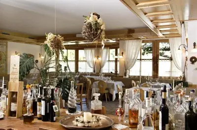 a room filled with bottles of wine on a table at Locanda Alpina in Brez