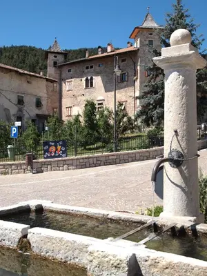 a water fountain in front of a building at Locanda Alpina in Brez