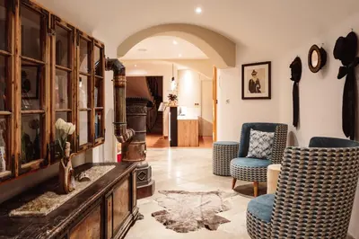 a living room with two chairs and a table at Turmchalet Adults Only in Braies