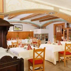 a dining room with white tables and chairs at Turmchalet Adults Only in Braies