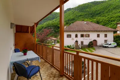 a view from the balcony of a house with a table and chairs at Ferienwohnungen Wieserhof in Andrian in Andrian