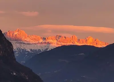 a view of a mountain range at sunset at Ferienwohnungen Wieserhof in Andrian in Andrian