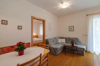 a living room with a couch and a table at Ferienwohnungen Wieserhof in Andrian in Andrian
