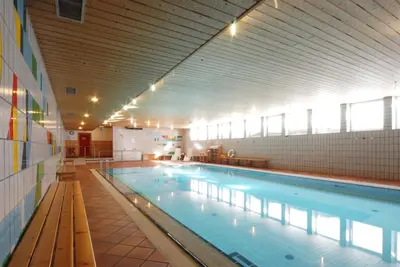a large swimming pool in a large building at Sport Hotel Pampeago in Tesero