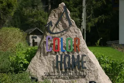 a rock sign with the words god hope on it at Color Home Suite Apartments in Predazzo