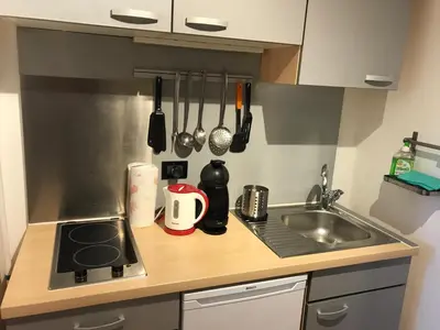 a small kitchen with a sink and a stove at Living Apartment Central in Merano
