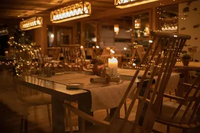 a dining room with a table with a candle and chairs at Kircherhof in Bressanone