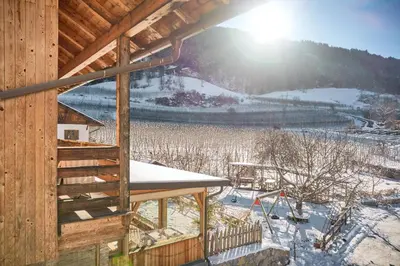 a winter view of a cabin with snow on the ground at Kircherhof in Bressanone