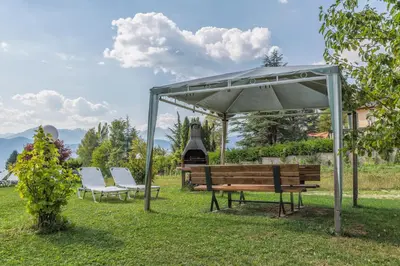 a group of benches under a gazebo at Affittacamere Villa Belfiore in Ronzone