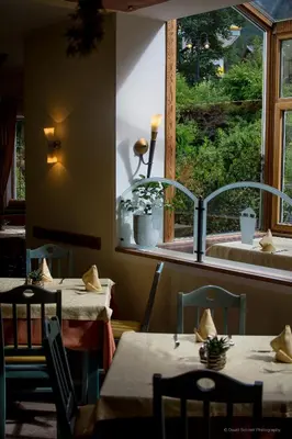 a restaurant with two tables and a window at Dolomit Boutique Hotel in La Villa