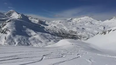 a snow covered mountain with ski tracks in the snow at Alfred Ties Apartments in San Vigilio Di Marebbe