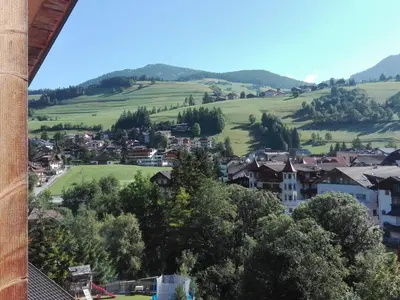 a view of a village in the hills at Alfred Ties Apartments in San Vigilio Di Marebbe