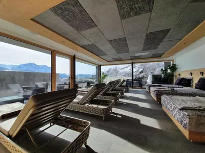 a room with a bunch of chairs and windows at Hotel Andechserhof & Mountain Sky in Laion