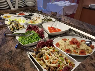 a buffet with many plates of food on a table at Hotel FleurAlp in Cermes