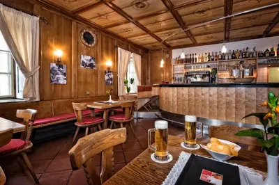 a restaurant with tables and chairs and a bar at Emma Historic Hotel in Villabassa