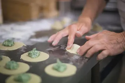 a person making cactus cookies on a table at Emma Historic Hotel in Villabassa