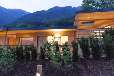 a house with a mountain in the background at Hotel-Chalet Pennhof in Barbiano