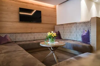a room with a couch and a table with flowers at Hotel Förstlerhof in Postal