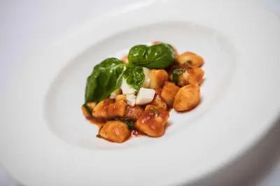 a white plate with food on a white plate at Hotel Förstlerhof in Postal