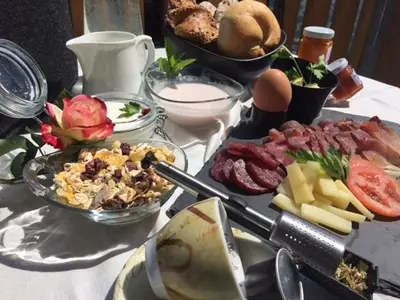 a table with many different types of food on it at Rofenhof in Naturno