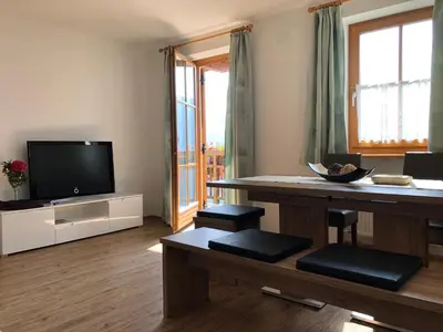a living room with a television and a table at Rofenhof in Naturno