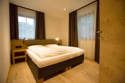 a bedroom with a bed and a window at Rofenhof in Naturno