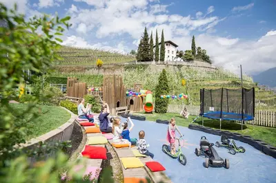 a group of children playing in a water park at Das Grafenstein Familienresidence in Cermes