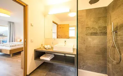 a bathroom with a sink and a shower at Residence Wiesenhof in Vollan