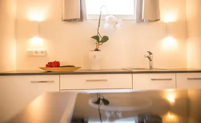 a kitchen with a sink and a flower in a vase at Residence Wiesenhof in Vollan