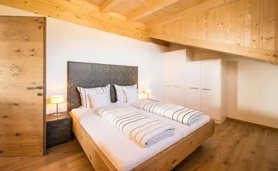 a bedroom with a large bed with two pillows at Residence Wiesenhof in Vollan